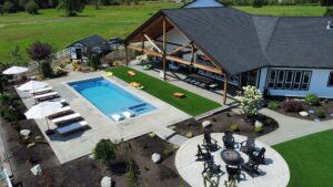 fiberglass pool and spa with swim-up seating in Washington backyard