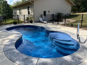 small fiberglass pool in Washington backyard with safety fence