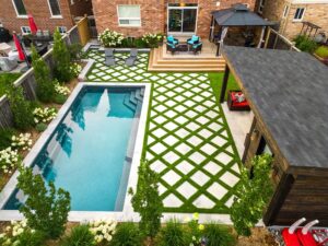 compact fibreglass pool in small Ontario backyard with creative landscaping