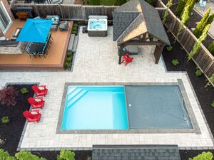 rectangular fibreglass pool with safety cover in suburban Ontario backyard