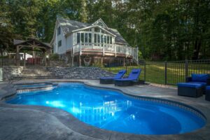 spacious fiberglass pool in large backyard