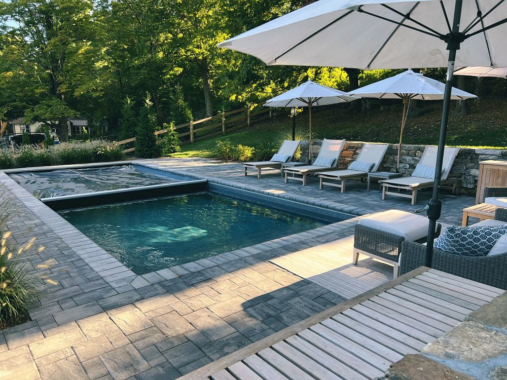 safety cover closing over rectangular fiberglass pool in Connecticut backyard