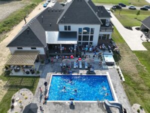 pool party in suburban backyard with kids playing in vinyl liner pool