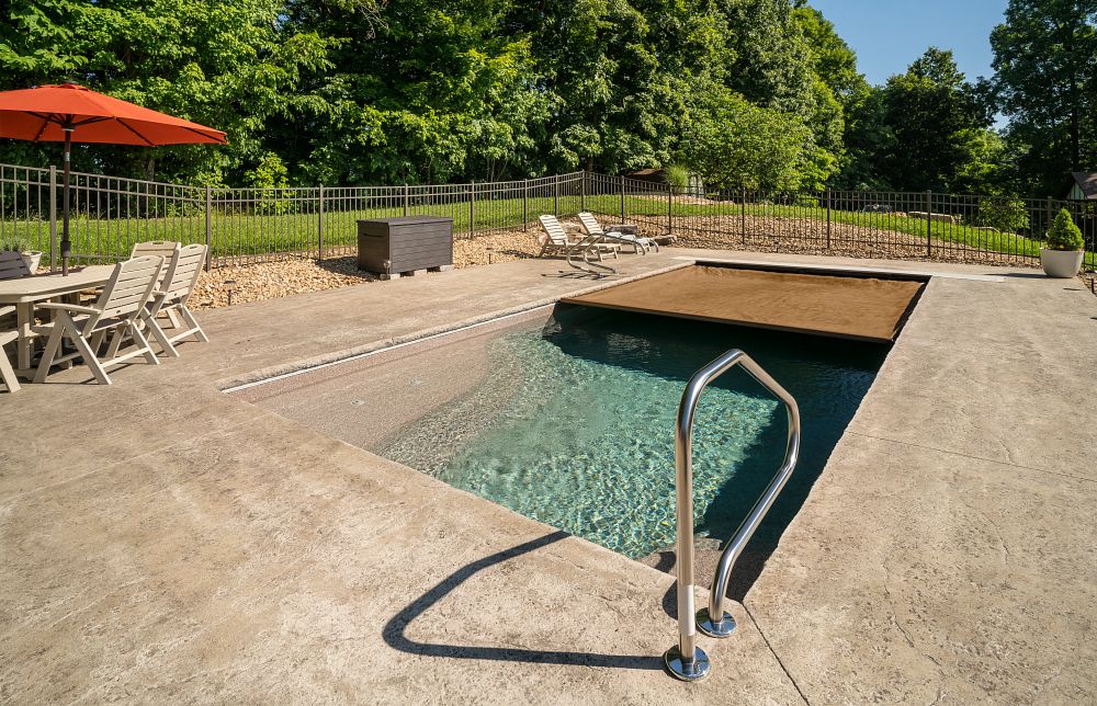 automatic pool cover opening over rectangular fiberglass pool