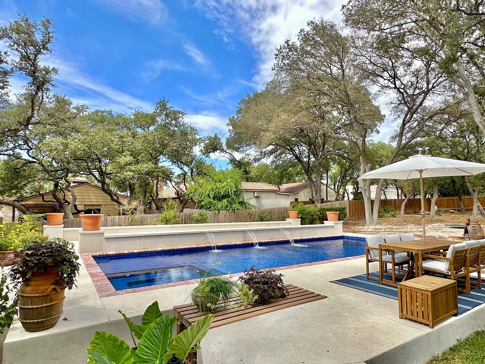 fiberglass pool with built-in spa and custom water features