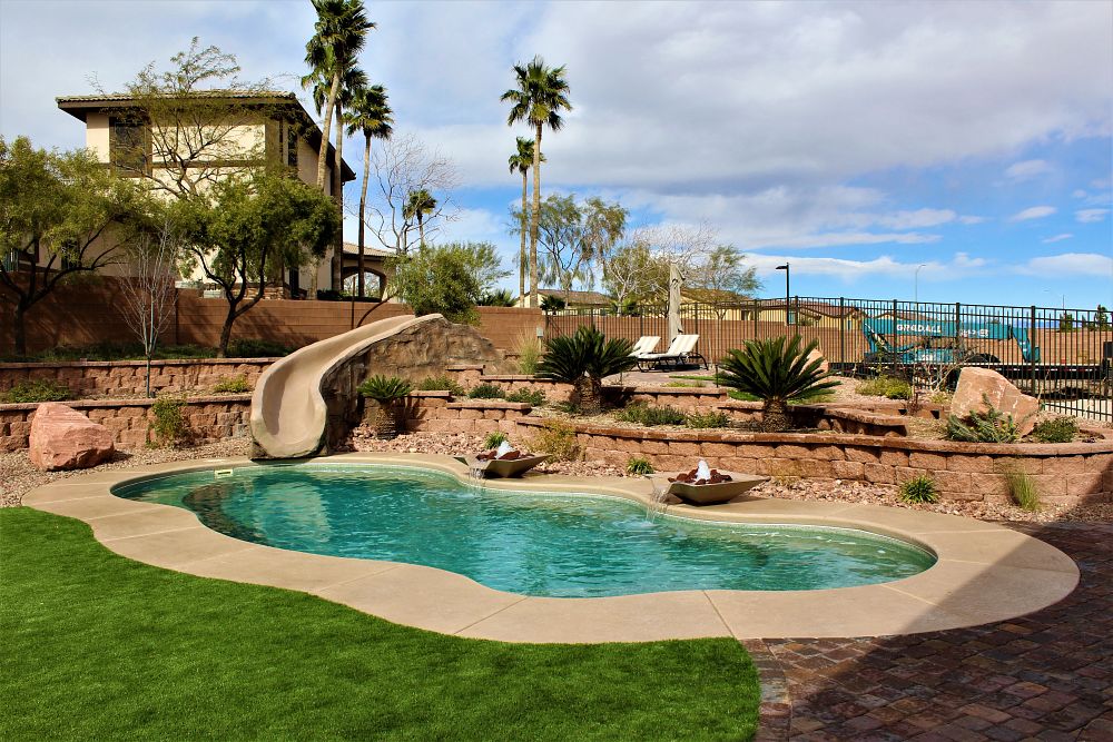 fiberglass pool with aesthetic waterslide and custom water features