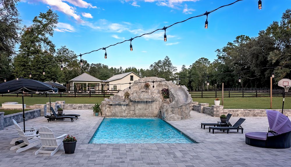 custom built pool slide leading into fiberglass pool